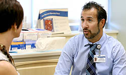 Dr. Virgilio George talks with a patient